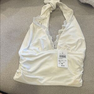 Please see stains on shirt. Brand new with tags but stains